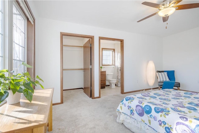 bedroom featuring light carpet and ensuite bath