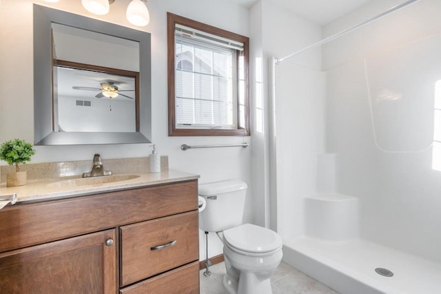 bathroom featuring tile patterned flooring, a shower, vanity, and toilet