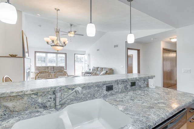 kitchen with vaulted ceiling, sink, a notable chandelier, and decorative light fixtures