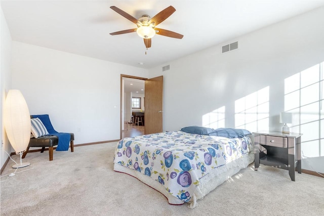 bedroom featuring light carpet and ceiling fan