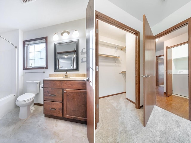 full bathroom featuring bathtub / shower combination, vanity, washer / clothes dryer, and toilet