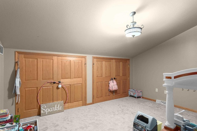 interior space featuring lofted ceiling and light carpet