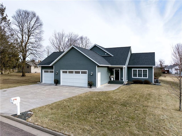 view of front of property with a front yard and a garage