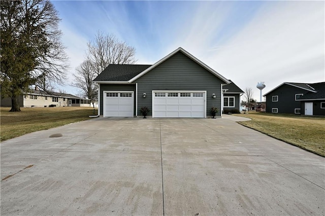 view of front of home with a front lawn and a garage