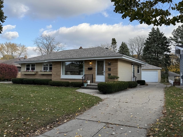 ranch-style house with an outbuilding, a front yard, and a garage