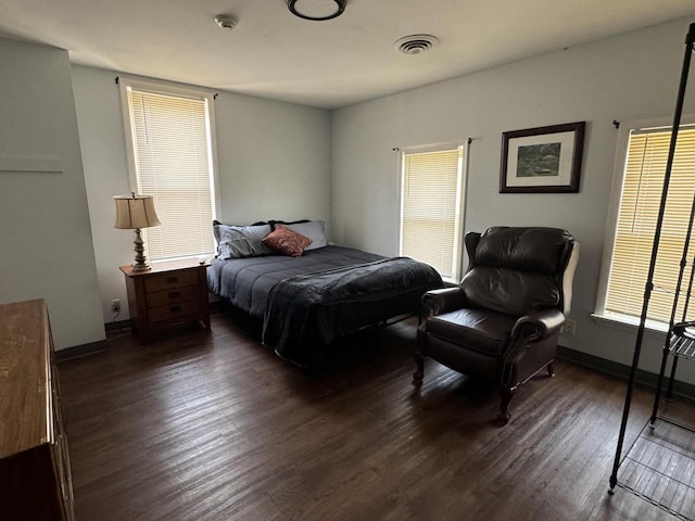 bedroom with dark wood-type flooring