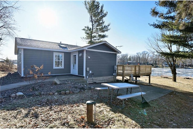 view of front of home with a deck with water view