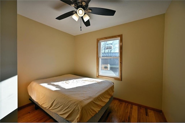 bedroom featuring dark hardwood / wood-style floors and ceiling fan