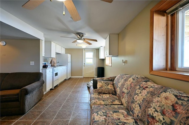 living room with dark tile patterned flooring and ceiling fan