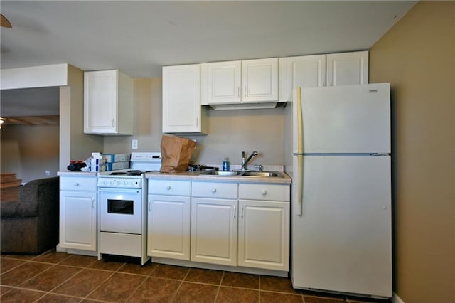 kitchen with ceiling fan, sink, dark tile patterned floors, white appliances, and white cabinets