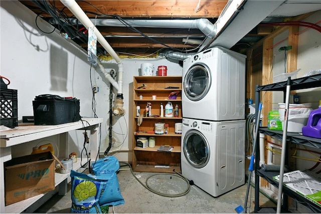 clothes washing area featuring stacked washer and clothes dryer