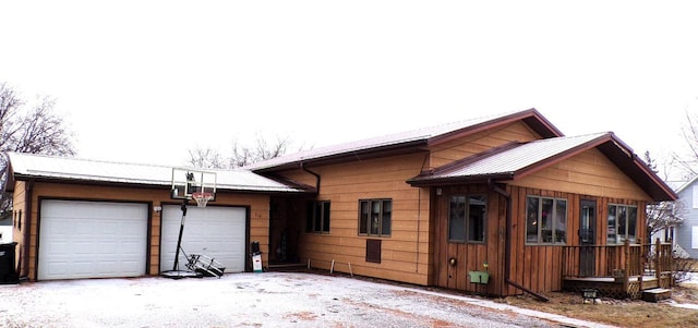 snow covered property with a garage