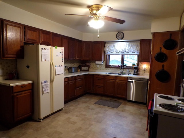 kitchen featuring decorative backsplash, ceiling fan, sink, and white appliances