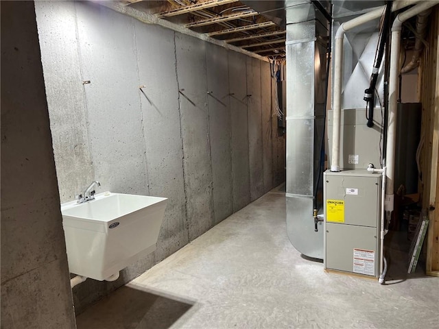 basement featuring sink and heating unit