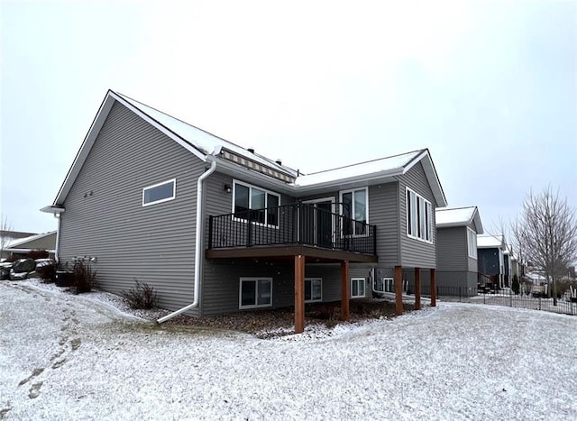 view of snow covered back of property