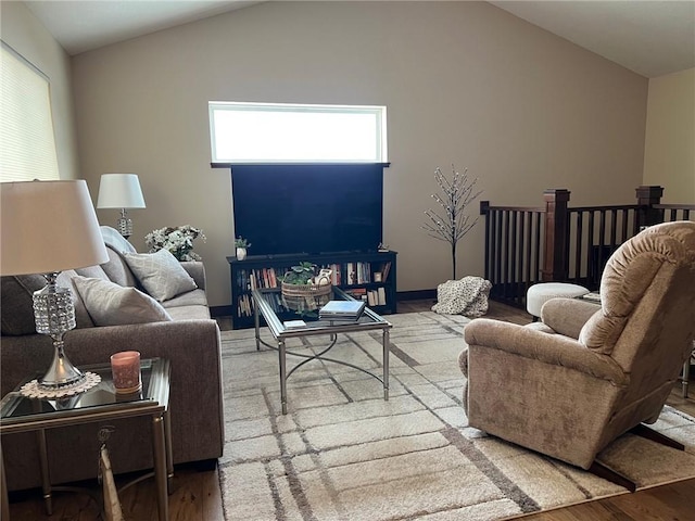 living room featuring wood-type flooring and vaulted ceiling