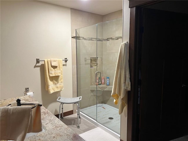 bathroom with a shower with door