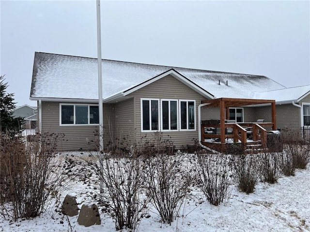 view of snow covered rear of property