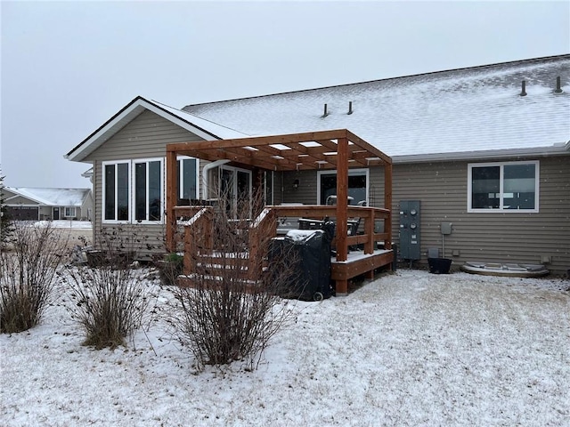 snow covered property featuring a wooden deck