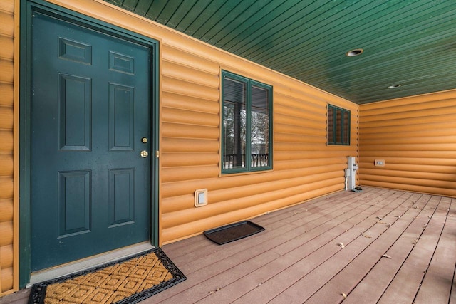 view of exterior entry with covered porch