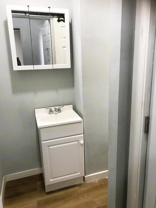 bathroom with vanity and hardwood / wood-style flooring