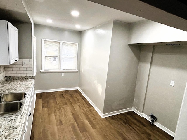 clothes washing area featuring dark hardwood / wood-style flooring and sink