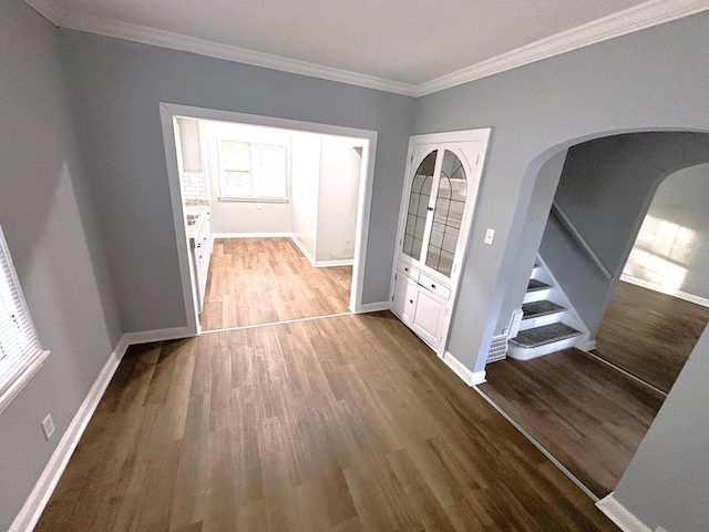 hallway with hardwood / wood-style flooring and crown molding