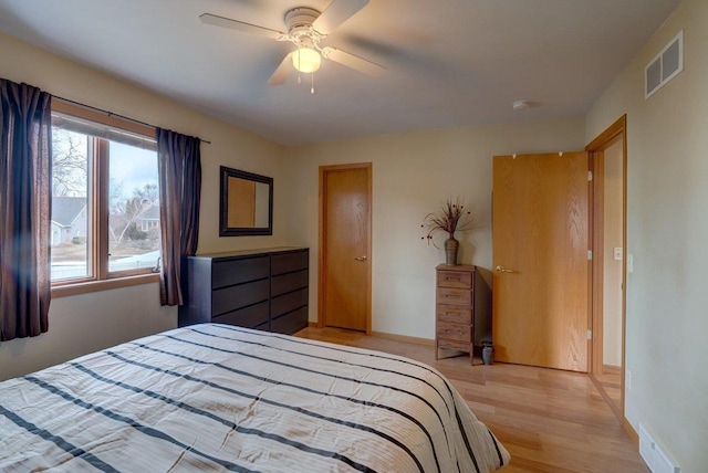 bedroom with ceiling fan and light wood-type flooring