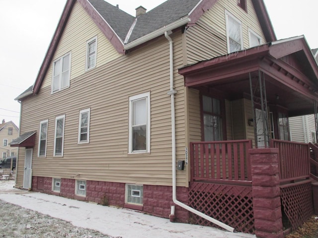 view of side of home with a porch