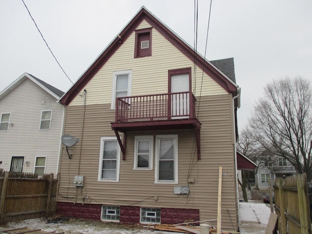 rear view of property with a balcony