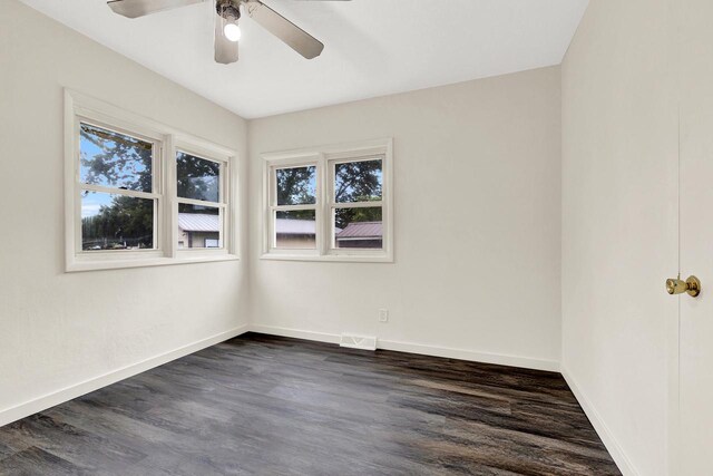 spare room featuring a wealth of natural light, dark hardwood / wood-style flooring, and ceiling fan