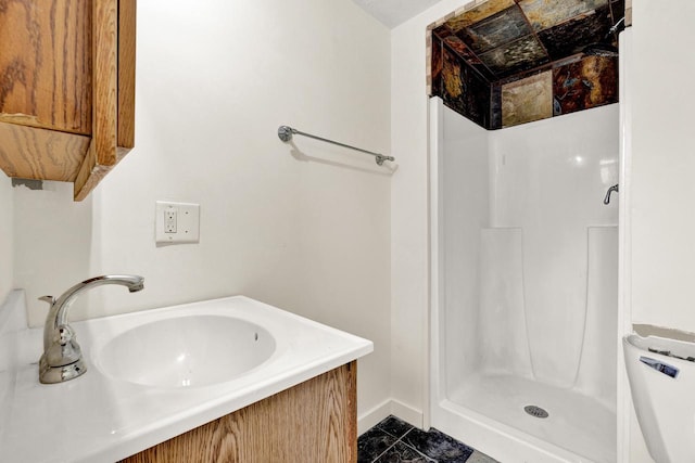 bathroom with tile patterned floors, a shower, and vanity