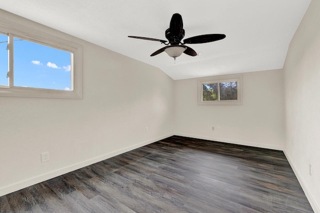 empty room featuring vaulted ceiling, ceiling fan, and dark hardwood / wood-style floors