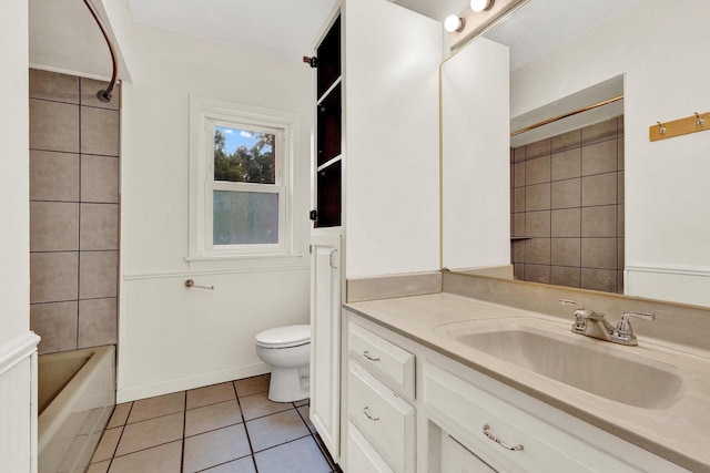 full bathroom featuring tile patterned floors, tiled shower / bath, vanity, and toilet