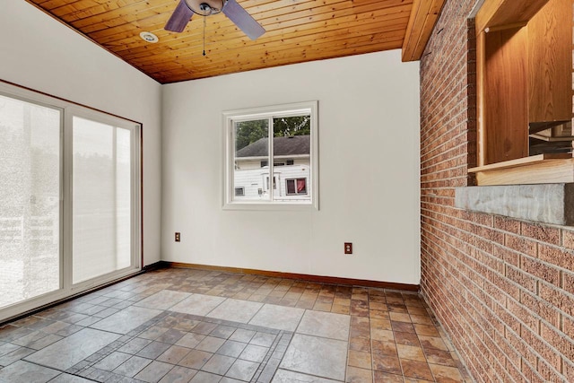 spare room featuring ceiling fan, wooden ceiling, and brick wall