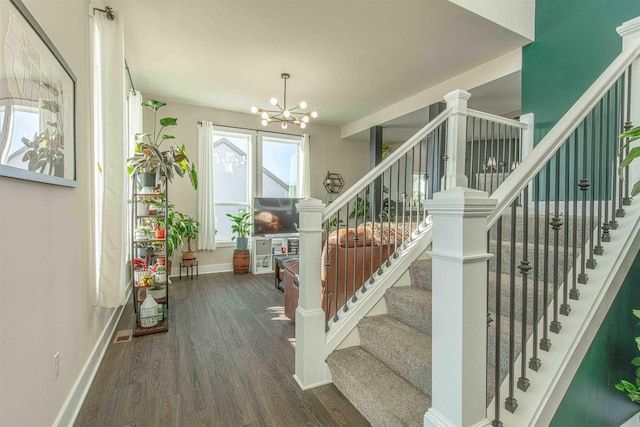 stairway featuring a notable chandelier and hardwood / wood-style floors