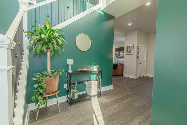 corridor with hardwood / wood-style flooring