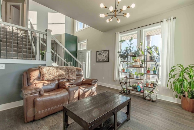 living room with a notable chandelier and hardwood / wood-style floors