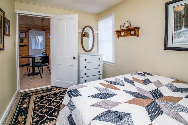 tiled bedroom featuring wood walls