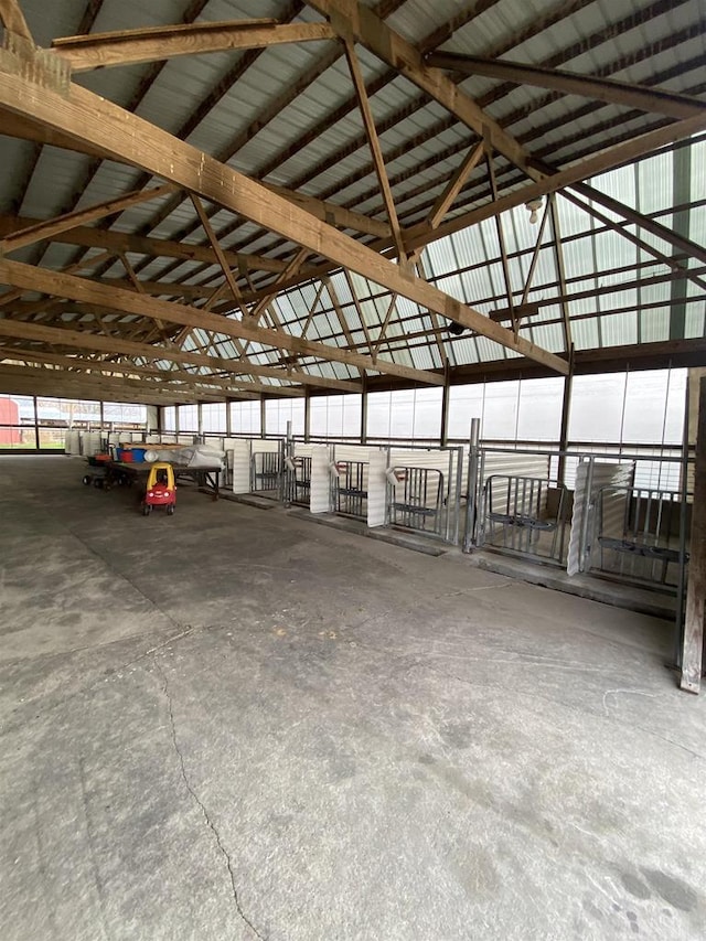 interior space with concrete flooring and high vaulted ceiling