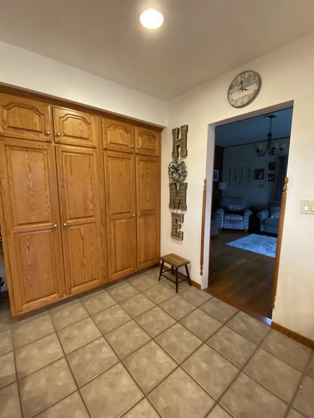 hall with light tile patterned floors