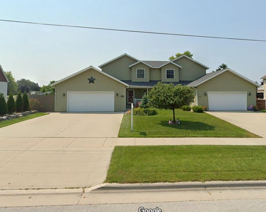 view of front of home featuring a garage and a front lawn