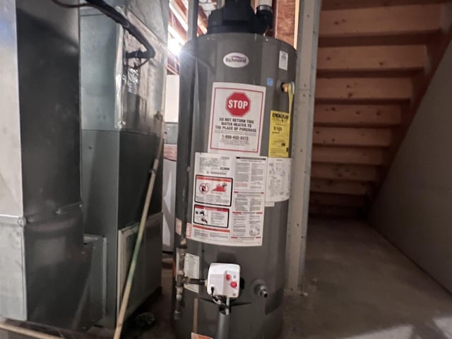 utility room featuring heating unit and gas water heater