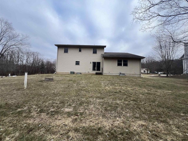 rear view of property featuring a yard