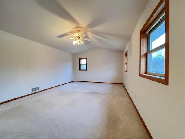 carpeted empty room featuring ceiling fan and lofted ceiling