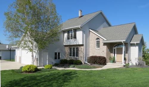 view of front of property with a garage and a front lawn