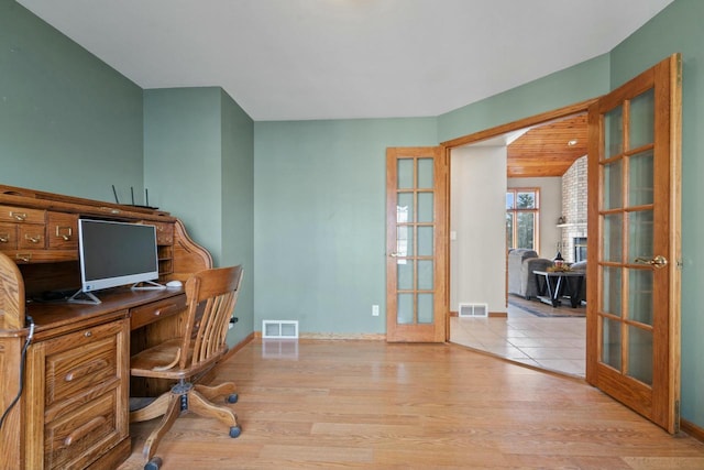 office space with french doors and light wood-type flooring