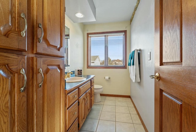 bathroom with toilet, tile patterned floors, and vanity