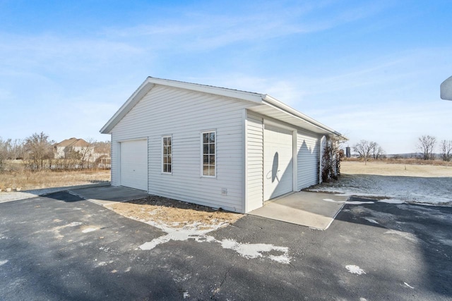 exterior space featuring a garage and an outdoor structure