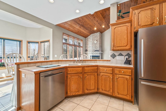 kitchen with sink, tile counters, tasteful backsplash, and appliances with stainless steel finishes